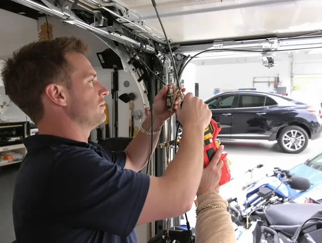 Huntersville Garage Door Repair safety certified technician performing cable replacement in Huntersville